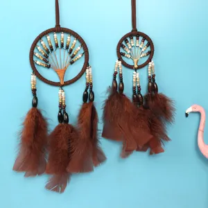 Detailed close-up view of the brown tree of life dreamcatcher with feathers and beads.