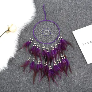 Attrape-reves violet mural avec plumes et perles en bois pour la decoration interieure.