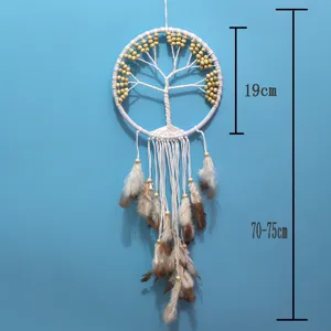 Detail view showing white Tree of Life dreamcatcher with beads and brown feathers