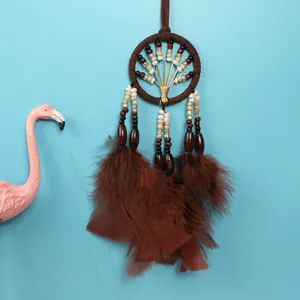 Detailed view of a brown lucky tree dream catcher car pendant with feathers and beads.