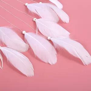 Detailaufnahme weißer Federn und Perlen für Traumfänger, minimalistischer Wohndekor-Anhänger.
