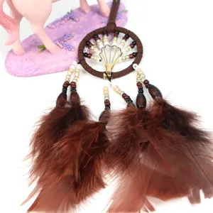 Close-up of brown feather dreamcatcher car hanging pendant with beads and woven ring details.