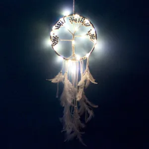 LED Tree of Life dreamcatcher with white feathers glowing in the dark