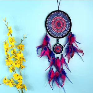 Handmade dream catcher detail showing intricate purple pink web design with layered feathers.
