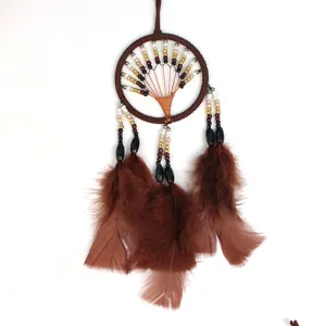 Tree of life dream catcher detail shot, brown feather hanging ornament for car and home decor.