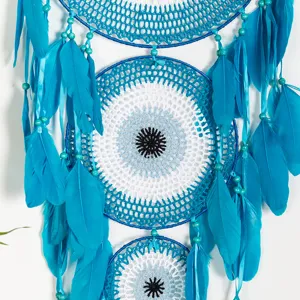Nahaufnahme des großen türkischen bösen Blick Traumfängers mit blauer Häkelarbeit und Federn.