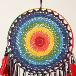 Large colorful handmade dream catcher wall hanging with feathers and beads for bedroom decor.