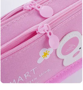 Trousse à crayons rose en toile à double couche avec de jolies applications et fermetures.
