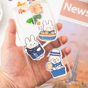 Cute cartoon bunny stickers decorating a transparent phone case for scrapbooking DIY