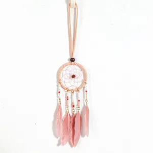 Detail view of ethnic pink dreamcatcher necklace with delicate feathers and beads