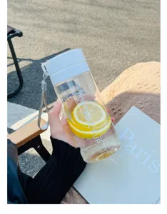 Detailed view of clear plastic water bottle filled with fresh lemon slices and water outdoors.