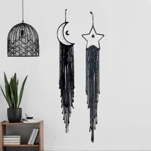 Detail shot of black handmade woven moon and star wall hanging tapestry bohemian room decor.