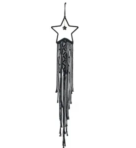 Black macrame star wall hanging detail, handmade woven boho room decor fringe tapestry.