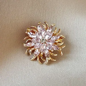 Exquisite gold-tone floral brooch with shimmering pink marquise-cut crystal petals