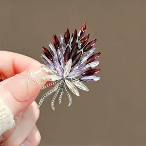 Close-up detail of a sparkling multi-color crystal brooch featuring an elegant floral design.