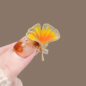 Exquisite ginkgo leaf brooch with orange enamel and crystal detail for women's wear