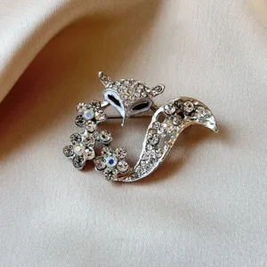Sparkling rhinestone fox brooch with floral details, elegant silver alloy fashion accessory.