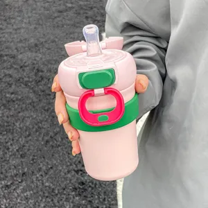 Pink insulated travel coffee mug with straw and portable strap for women, cute daily cup.