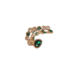 Elegant rhinestone ear cuff with green gems and golden metal design for stylish women.
