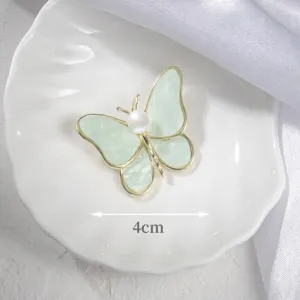 Elegant butterfly brooch with pearl detail, 4cm width shown on white plate