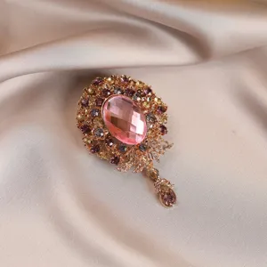 Vintage pink crystal flower brooch detailed view, elegant rhinestone decorative pin for women.