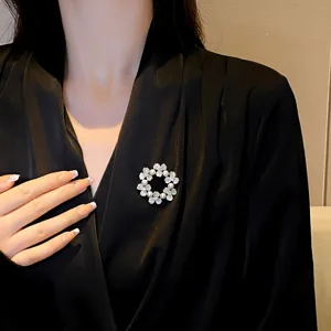 Exquisite rhinestone pearl garland brooch detail view, elegant fashion accessory and dress pin.