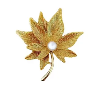 Elegant gold maple leaf brooch pin with white pearl accent for sweaters and suits accessory.