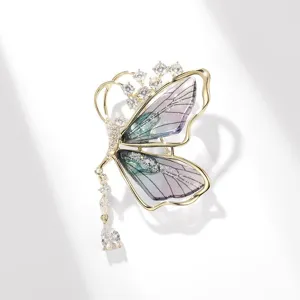 Elegant butterfly brooch featuring iridescent purple wings and sparkling crystal accents