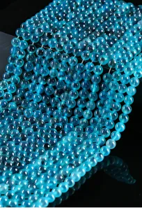 Macro detail of 6mm translucent blue candy heart agate round beads for DIY craft