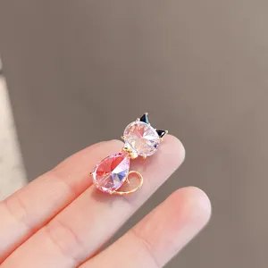 Crystal cat brooch detail, elegant pink gemstone lapel pin, shiny fashion accessory for women.
