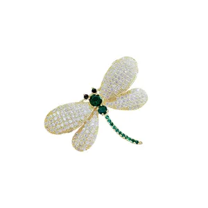 Exquisite rhinestone dragonfly brooch detail, luxury gold-tone suit pin and clothing accessory.