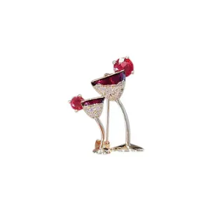 Detailed close-up of elegant wine glass brooch with sparkling red and clear gemstones