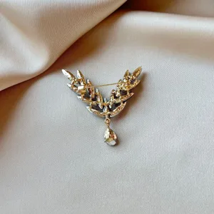 Detailed view of the exquisite crystal angel wing brooch back with a secure pin and drop stone.