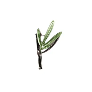 Elegant green bamboo leaf brooch pin with dark metallic stem and enamel finish for coats