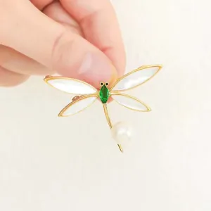 Exquisite dragonfly brooch detail showing mother of pearl wings and green gemstone body.