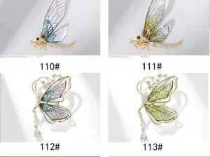 Close-up details of translucent butterfly brooch variants with sparkling zircon crystals.