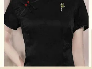 Elegant black cheongsam top paired with a delicate crystal butterfly tassel brooch for women.