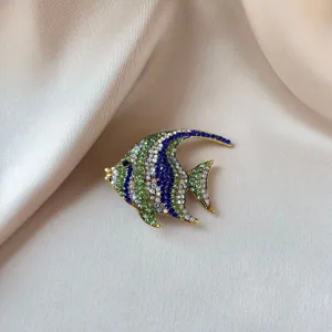 Elegant tropical fish brooch adorned with sparkling green and blue rhinestones on silk