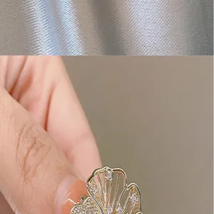 Exquisite metal rhinestone brooch detail, elegant fan-shaped design, perfect suit accessory.