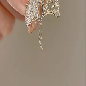 Elegant ginkgo leaf brooch pin with sparkling cubic zirconia, chic lapel suit accessory for women.