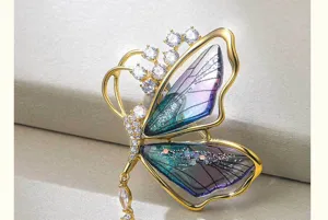 Exquisite translucent gradient butterfly brooch with dazzling zircon and tassel detail for women.