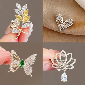 Elegant crystal brooch pin set featuring leaf, heart, butterfly, and lotus designs for women.