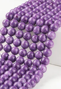 Close-up detail of purple imitation charoite round loose beads for DIY jewelry making