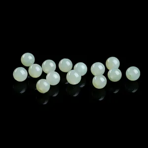 Macro detail of natural pale green Qinghai Hetian jade loose beads for DIY jewelry.