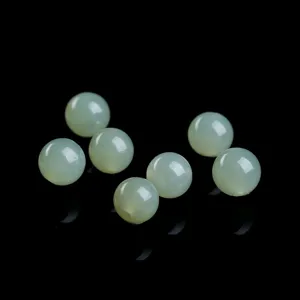 Detailed view of natural light green Qinghai Hetian jade loose beads for DIY jewelry