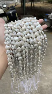 Macro detail of natural white iridescent baroque pearl strands for DIY jewelry making