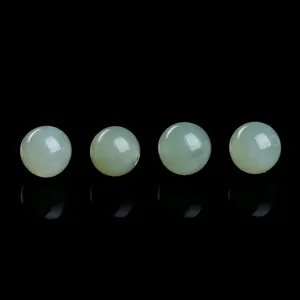 Macro view of four translucent celadon nephrite jade beads for DIY jewelry making