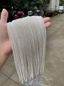 Macro view of lustrous natural white freshwater pearl strands for DIY jewelry making.