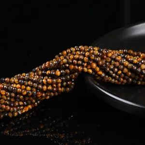 Detailed macro view of faceted natural yellow tiger eye round beads for DIY jewelry.