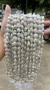 Close-up view of lustrous white natural baroque coin pearls for DIY jewelry making accessories